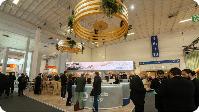 A wide shot of attendees at the Expedia Group booth at the ITB conference.