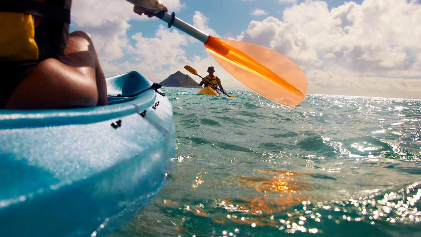 Two people in kayaks paddling on the water
