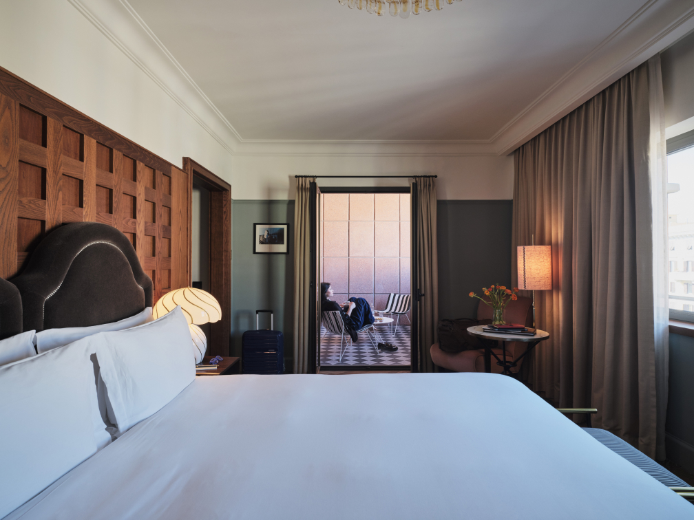 A large freshly made hotel room bed