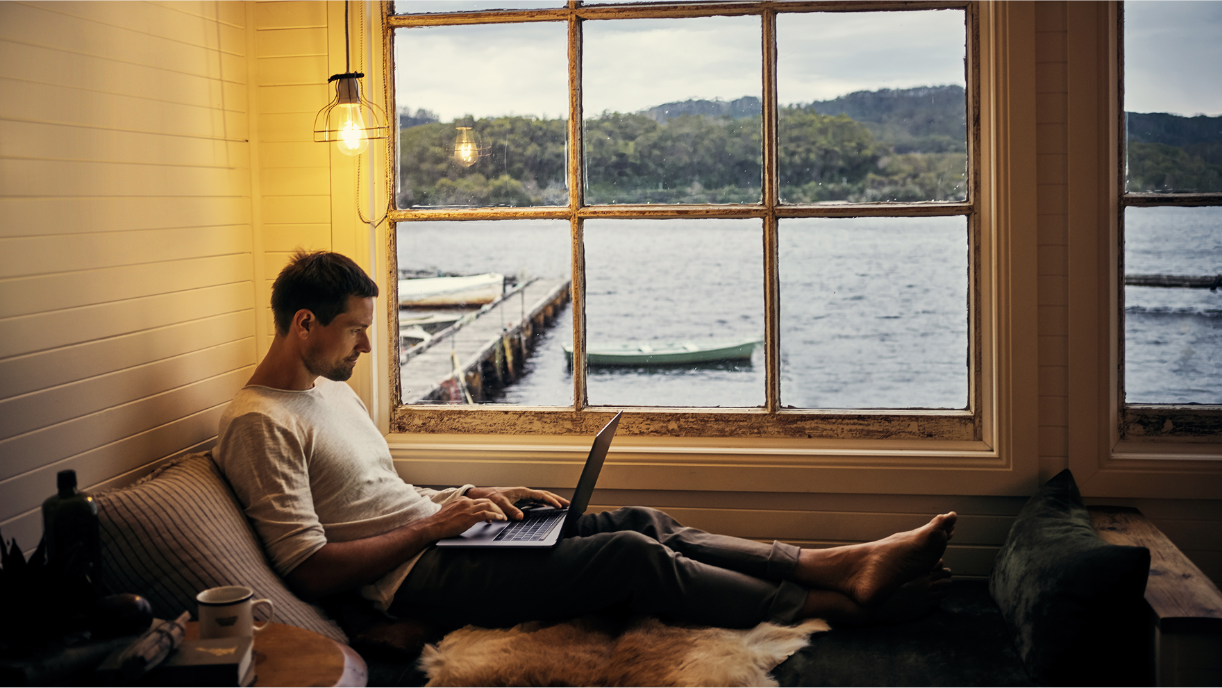 A man sitting working on his laptop